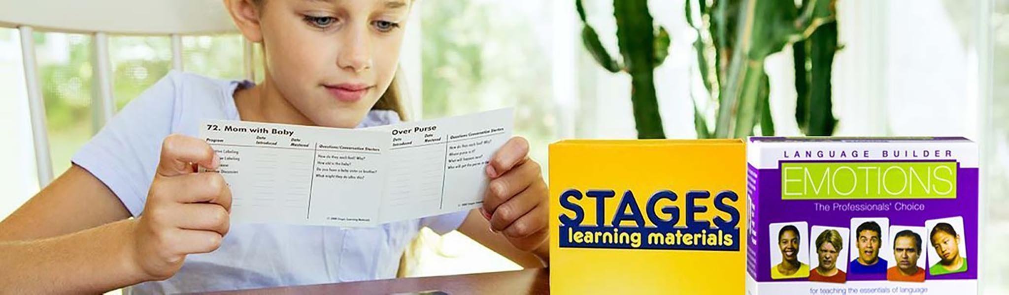 Girl looking at flashcards with set of Language Builder Emotion Cards in the forefront