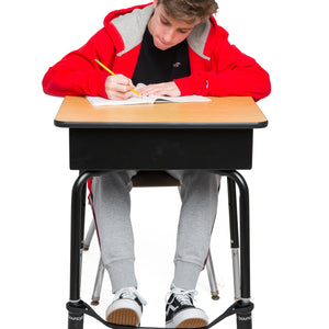 A Young Boy Studying on a Desk with a Black Bouncyband